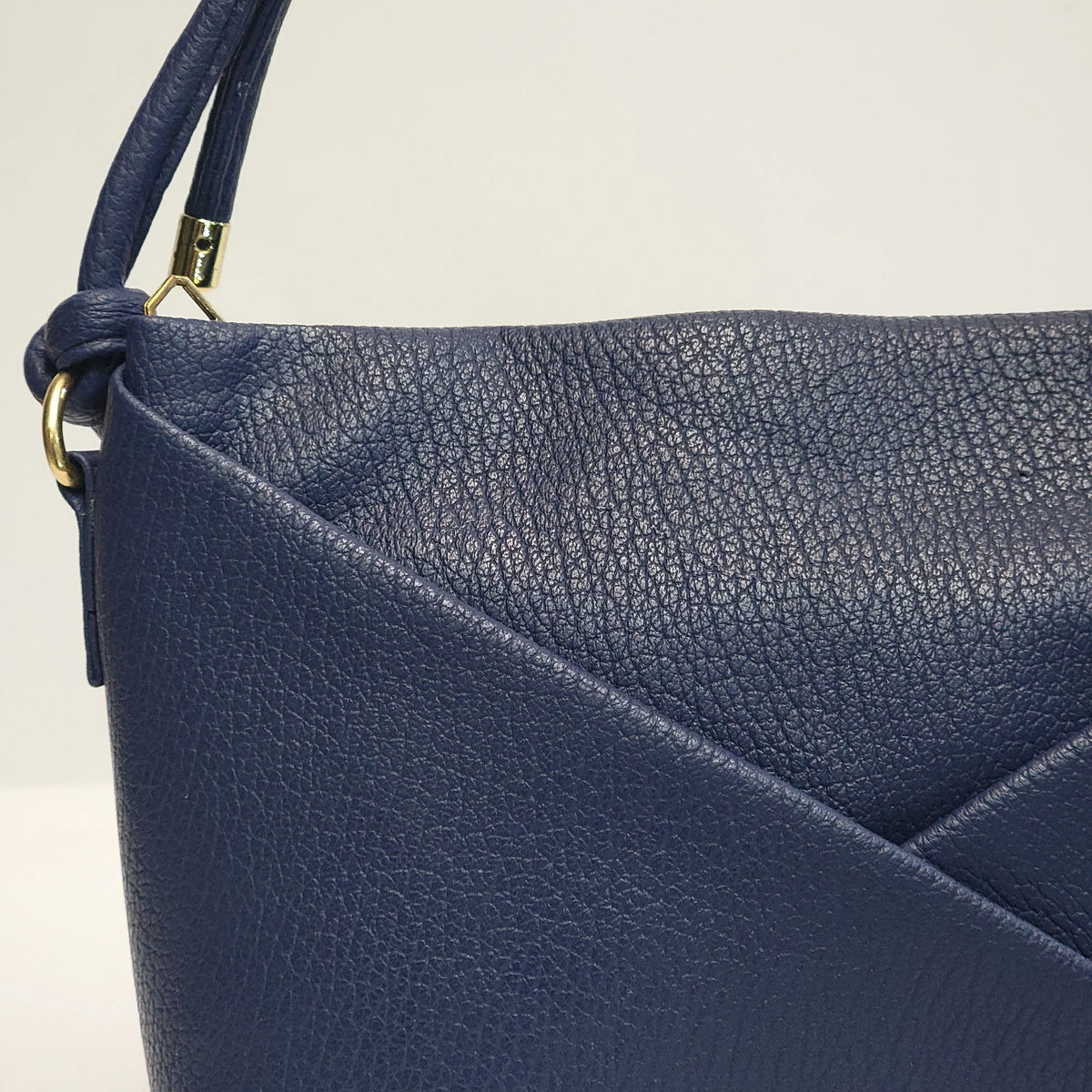 Cross B. navy blue envelope-style crossbody bag, side view