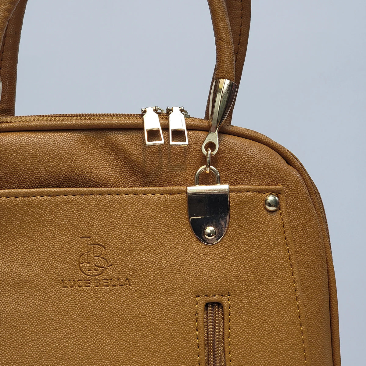 Cross B. tan faux-leather backpack, close-up of front zip pockets and hardware
