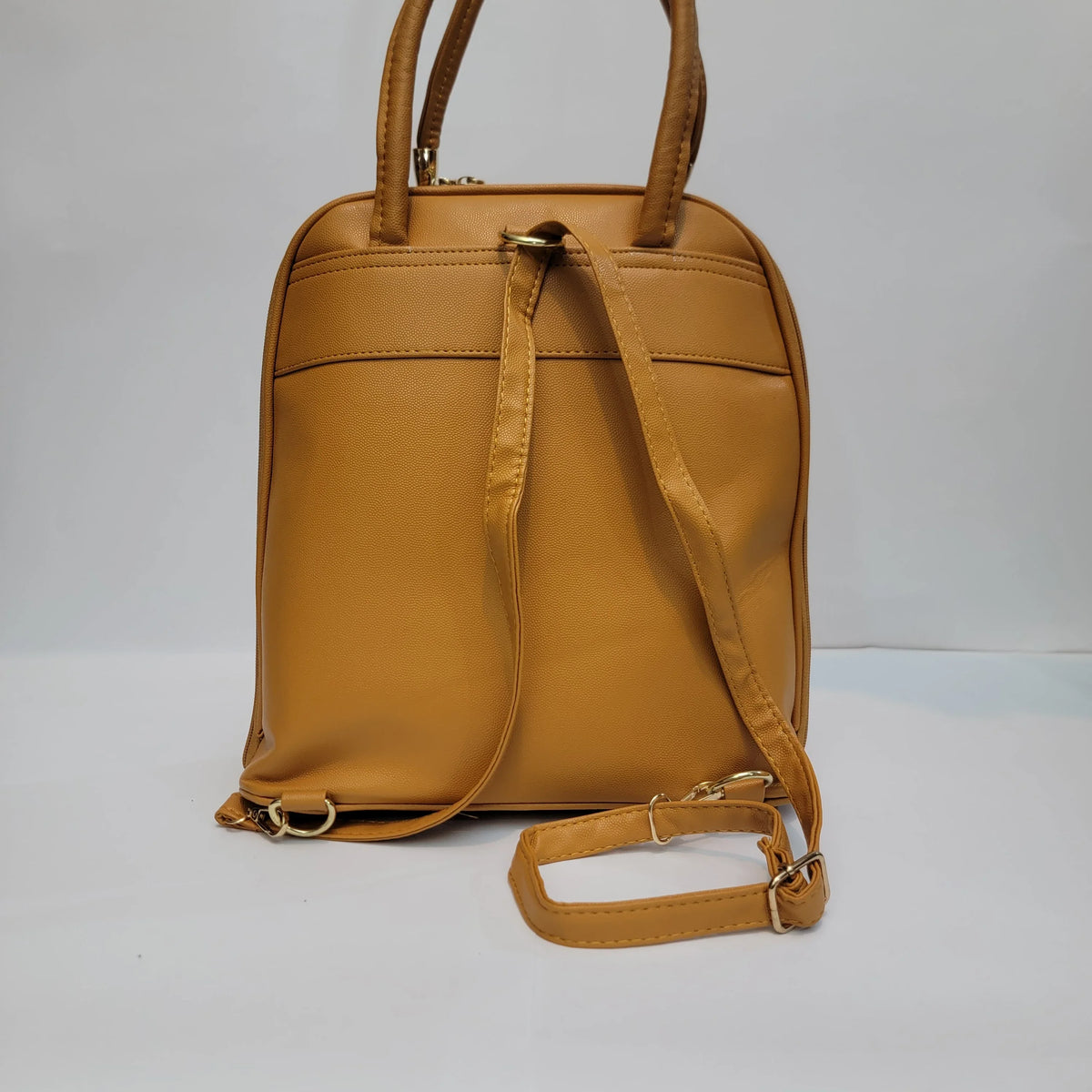 Cross B. tan faux-leather backpack, side view showing adjustable straps