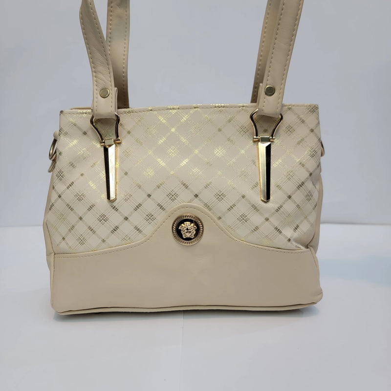 A structured handbag in cream faux leather with a subtle diamond pattern on the upper section, a smooth lower panel, and gold-tone hardware accents.