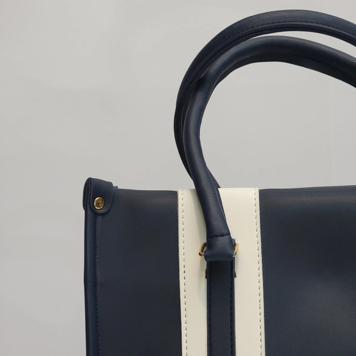 Cross B. navy blue structured tote bag, close-up of stripe panel and hardware