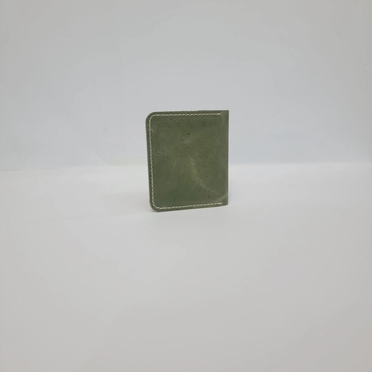 An olive green leather card holder or wallet with white contrast stitching, shown against a plain white background.