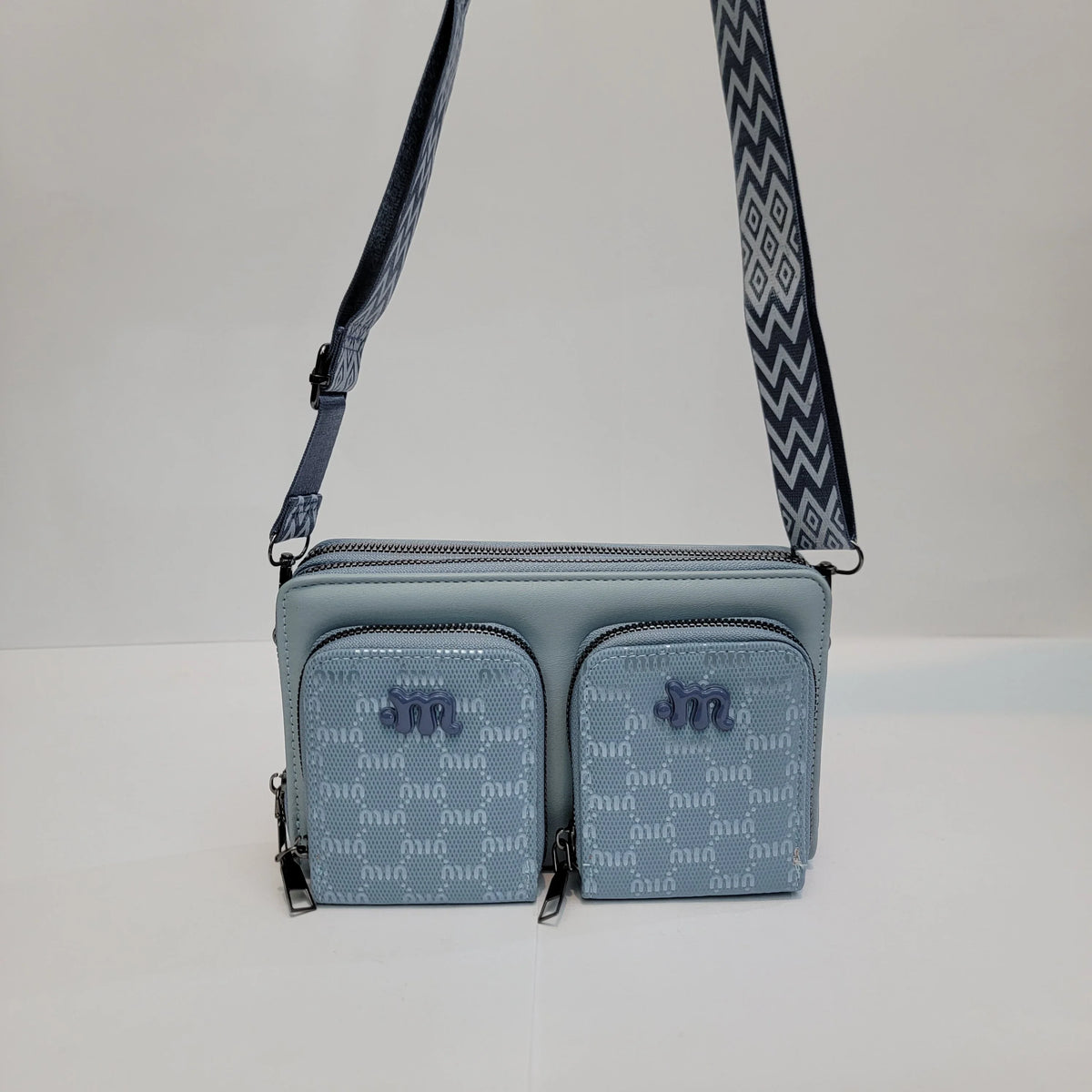 Cross B. blue crossbody bag with double front pockets, front view