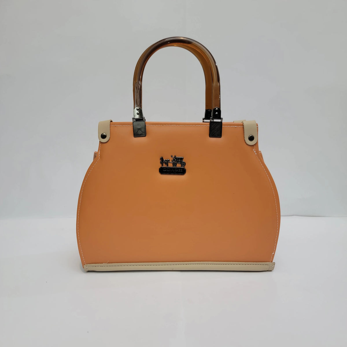 An orange structured handbag with a top handle, beige trim, and a small black horse logo on the front, photographed against a plain light gray background.