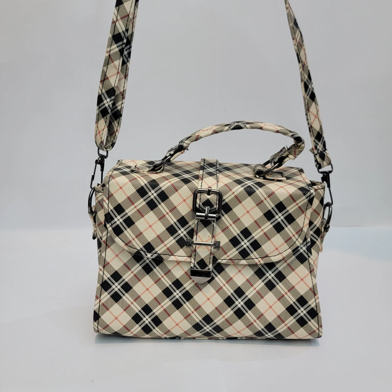 A structured handbag with a beige, black, and brown plaid pattern, featuring a top handle, a detachable shoulder strap, and a front flap secured by a silver buckle.