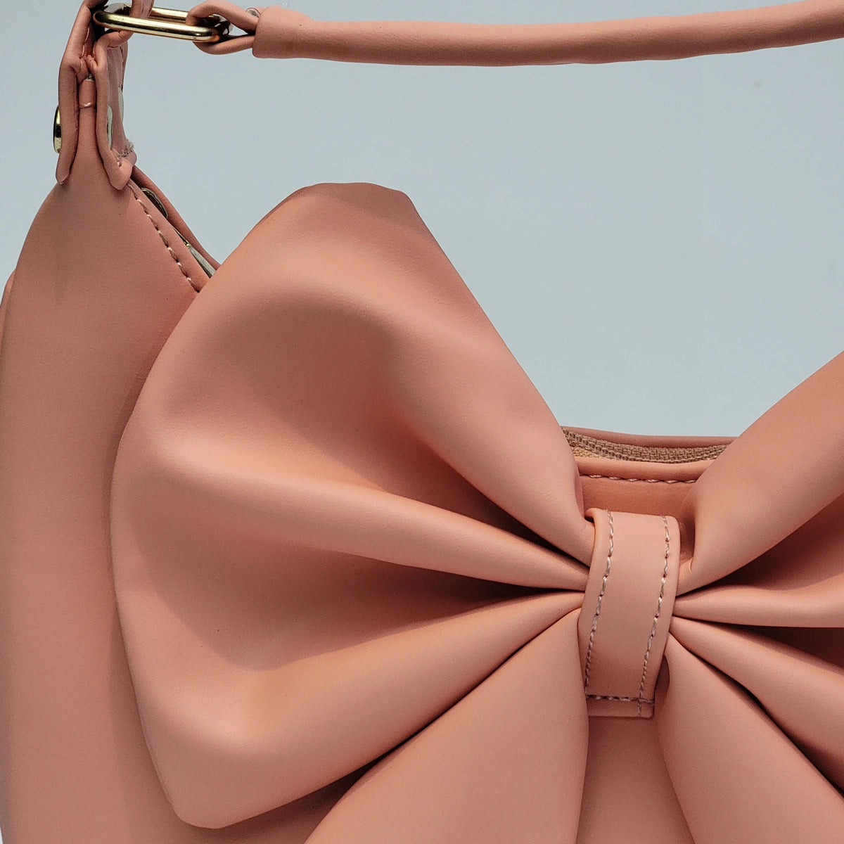 Cross B. bow-detail shoulder bag, close-up of bow and hardware, second colorway