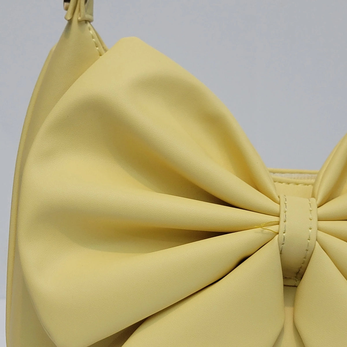 Cross B. bow-detail shoulder bag, close-up of bow and hardware, fourth colorway