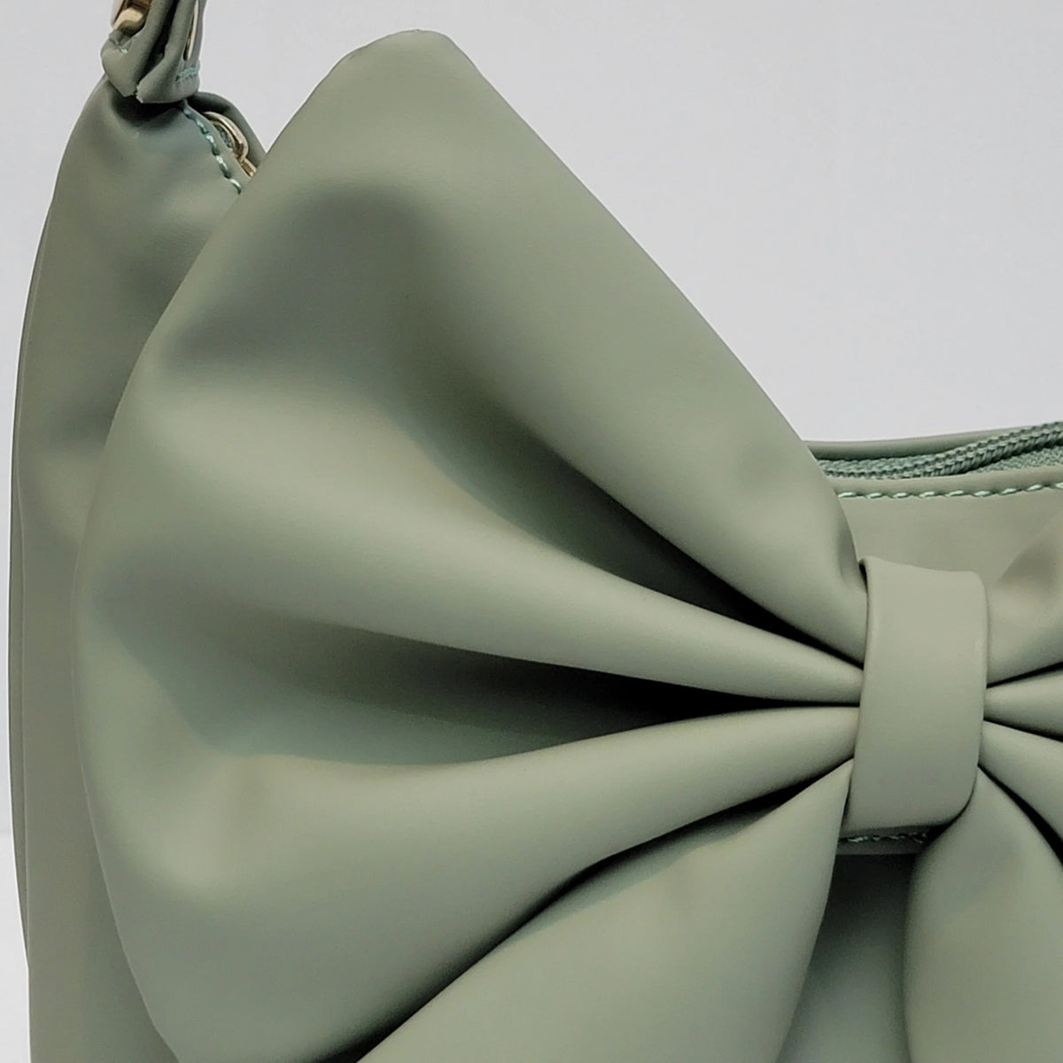 Cross B. bow-detail shoulder bag, close-up of bow and hardware, third colorway
