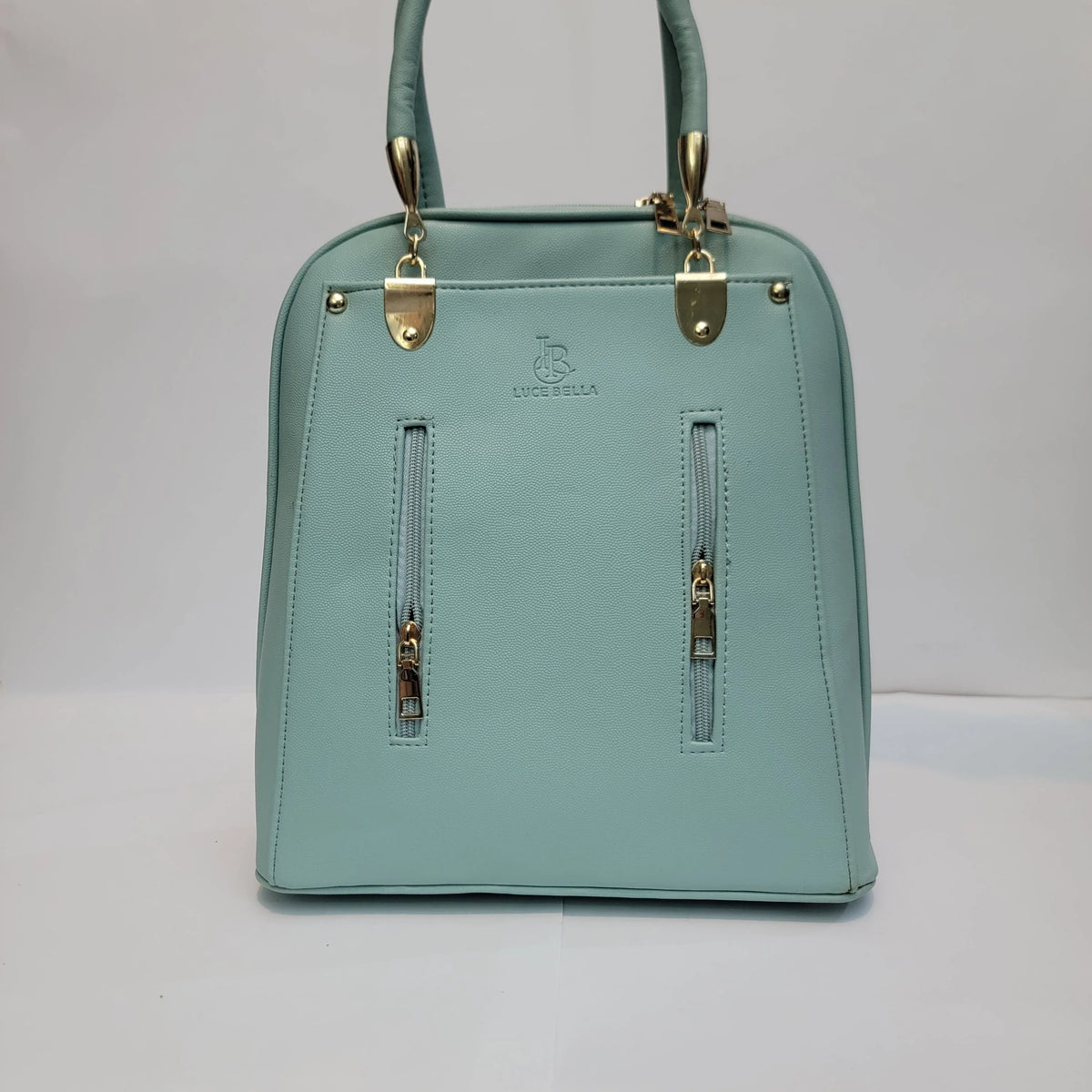 Cross B. sage green faux-leather backpack with gold-tone hardware, front view