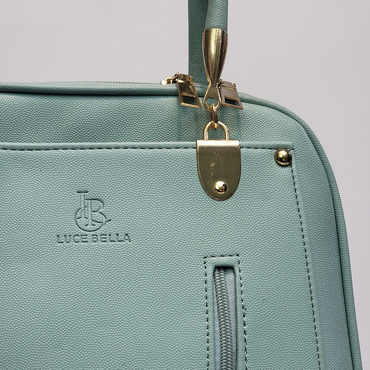 Cross B. sage green faux-leather backpack, close-up of front zip pockets and hardware