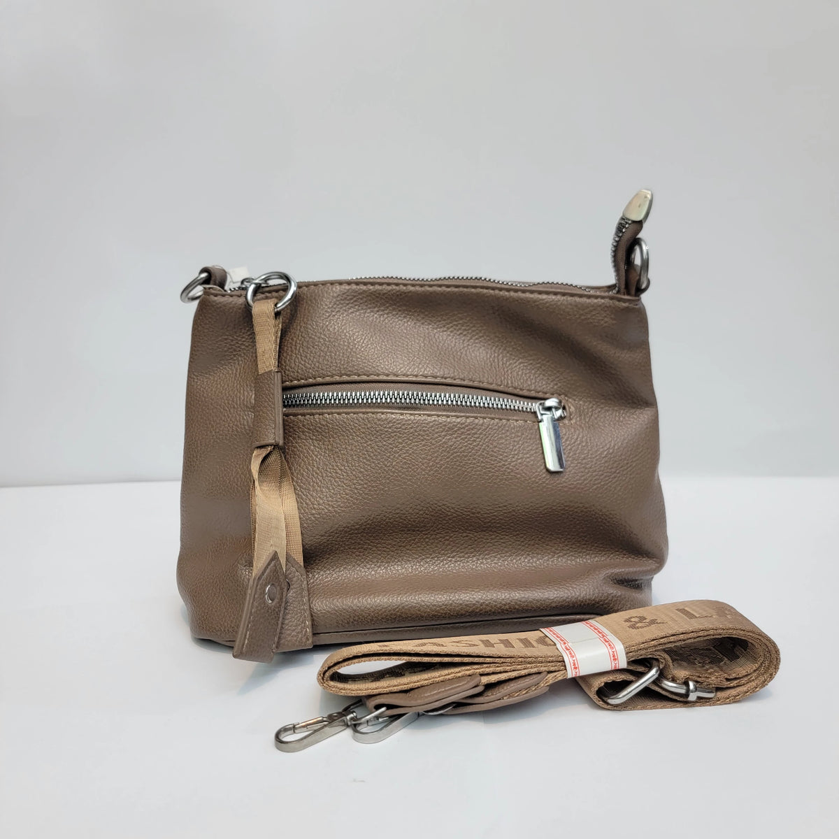 A taupe brown pebbled leather crossbody bag with a matching detachable woven strap, displayed on a clean white studio background.