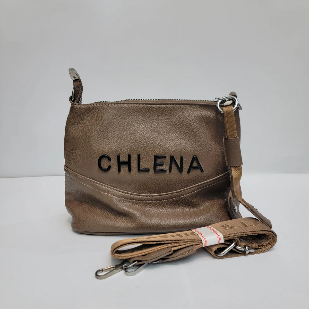 A taupe brown pebbled leather handbag with the brand name 'CHLENA' embossed on the front, featuring a matching leather shoulder strap with silver hardware, set against a plain light gray background.